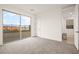 Bright carpeted bedroom with sliding glass doors providing an outdoor view at 11676 Midnight Melody Ave, Las Vegas, NV 89138