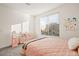 Bright bedroom showcasing a large window, plush carpet, and charming decor at 11676 Midnight Melody Ave, Las Vegas, NV 89138