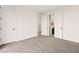 Cozy bedroom with neutral carpet, multiple closet doors and access to ensuite bathroom at 11676 Midnight Melody Ave, Las Vegas, NV 89138