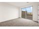 Bright, carpeted bedroom with sliding glass doors leading to an outdoor space at 11676 Midnight Melody Ave, Las Vegas, NV 89138