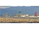 Expansive city view overlooking treetops with the skyline and distant mountains at 11676 Midnight Melody Ave, Las Vegas, NV 89138