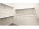 Walk-in closet featuring carpet and shelving for ample storage at 11676 Midnight Melody Ave, Las Vegas, NV 89138