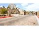 Community entrance featuring well-maintained landscaping, stone walls, and gated access at 11676 Midnight Melody Ave, Las Vegas, NV 89138