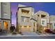 Contemporary three-story home with a two-car garage, balcony, and modern architectural design at 11676 Midnight Melody Ave, Las Vegas, NV 89138