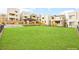 Expansive green space in a residential area featuring modern townhomes and landscaped surroundings at 11676 Midnight Melody Ave, Las Vegas, NV 89138