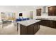 Modern kitchen with a large island, stainless steel appliances, and open access to living area at 11676 Midnight Melody Ave, Las Vegas, NV 89138