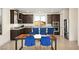 Bright, open kitchen featuring dark cabinets, granite countertops, stainless steel appliances, and stylish bar stool seating at 11676 Midnight Melody Ave, Las Vegas, NV 89138