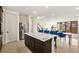 Open concept kitchen with an island, stainless steel appliances, and access to the living area at 11676 Midnight Melody Ave, Las Vegas, NV 89138