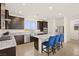 Well-lit kitchen featuring stainless steel appliances, a central island with seating, and outside view at 11676 Midnight Melody Ave, Las Vegas, NV 89138
