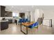 Spacious kitchen with granite counters, stainless steel appliances, and island seating that flows into dining at 11676 Midnight Melody Ave, Las Vegas, NV 89138