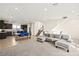 Bright, open-concept living space with a modern kitchen, dining area, and comfortable seating at 11676 Midnight Melody Ave, Las Vegas, NV 89138