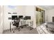 Bright home office with multiple monitors, comfortable ergonomic chair, and sliding door access at 11676 Midnight Melody Ave, Las Vegas, NV 89138