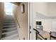 View of a staircase leading up into a home with living spaces that include a modern fireplace and dining area at 11676 Midnight Melody Ave, Las Vegas, NV 89138