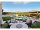 Stunning backyard showcasing an in-ground pool, lush landscaping, and an inviting outdoor seating area at 11878 Albissola Ave, Las Vegas, NV 89138