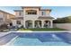 A stunning backyard with a pool, outdoor seating, and landscaping that accentuates the home's architecture at 11878 Albissola Ave, Las Vegas, NV 89138