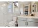 A bathroom features a glass shower and vanity with bright mirror and fixtures at 11878 Albissola Ave, Las Vegas, NV 89138