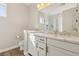 Bright bathroom with double vanity, white cabinetry and hardwood floors at 11878 Albissola Ave, Las Vegas, NV 89138
