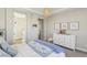 Cozy bedroom with neutral tones, carpet flooring and view into the on suite bathroom at 11878 Albissola Ave, Las Vegas, NV 89138