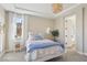 Bright bedroom with a queen size bed, neutral walls, white curtains, and a view of the mountains at 11878 Albissola Ave, Las Vegas, NV 89138