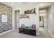 A well-appointed bedroom with decorative wall panels, shelf decor, and hallway leading to the bathroom at 11878 Albissola Ave, Las Vegas, NV 89138