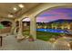 Covered patio featuring a decorative tile, hanging swing chairs, and a view of the inviting pool area at 11878 Albissola Ave, Las Vegas, NV 89138