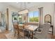 Cozy dining room featuring a large window, chandelier, and elegant seating at 11878 Albissola Ave, Las Vegas, NV 89138