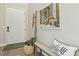 Inviting entryway with a white door, artwork, a welcome pillow, and a woven basket with a green plant at 11878 Albissola Ave, Las Vegas, NV 89138