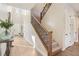 Inviting entryway featuring a staircase with wooden handrail and metal balusters and bright light at 11878 Albissola Ave, Las Vegas, NV 89138