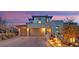 Beautiful two-story home featuring a three-car garage, stone accents, and lush landscaping at 11878 Albissola Ave, Las Vegas, NV 89138