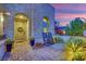 Charming front porch featuring stone accents, rocking chairs, and a welcoming entrance at 11878 Albissola Ave, Las Vegas, NV 89138