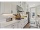 Modern kitchen with white cabinetry, stainless steel appliances, and a gas cooktop at 11878 Albissola Ave, Las Vegas, NV 89138