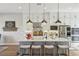 Modern kitchen featuring white cabinets, pendant lighting, stainless steel appliances, and a center island at 11878 Albissola Ave, Las Vegas, NV 89138