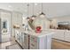 Beautiful kitchen featuring white cabinets, stainless steel appliances, a center island, and hardwood floors at 11878 Albissola Ave, Las Vegas, NV 89138