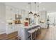 Stylish kitchen featuring white cabinets, stainless steel appliances, pendant lighting, and a center island with seating at 11878 Albissola Ave, Las Vegas, NV 89138
