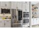 Kitchen featuring stainless steel appliances, double ovens, and sleek white cabinets at 11878 Albissola Ave, Las Vegas, NV 89138