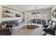 Inviting living area with movie style seating and a sliding glass doors to the outdoor patio at 11878 Albissola Ave, Las Vegas, NV 89138