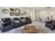Comfortable upstairs living area featuring home theater seating and neutral-colored carpet at 11878 Albissola Ave, Las Vegas, NV 89138
