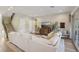 Open-concept living room with a staircase, hardwood floors, a large sectional sofa, and sliding glass doors to backyard at 11878 Albissola Ave, Las Vegas, NV 89138