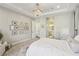 Spacious main bedroom with an ensuite bathroom, neutral tones, a chandelier, and bright natural lighting throughout at 11878 Albissola Ave, Las Vegas, NV 89138