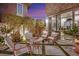Charming outdoor seating area featuring comfortable furniture and lush landscaping for relaxation and enjoyment at 11878 Albissola Ave, Las Vegas, NV 89138