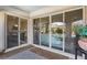 Covered patio features tiled flooring and sliding glass doors leading to the home's interior at 11878 Albissola Ave, Las Vegas, NV 89138