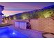 Poolside view featuring a functional brick retaining wall, pool equipment and neatly trimmed hedges at 11878 Albissola Ave, Las Vegas, NV 89138