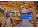 Inviting backyard features a sparkling pool, outdoor dining area with a grill, perfect for entertaining at 11878 Albissola Ave, Las Vegas, NV 89138