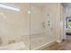 Bright bathroom showcasing a glass shower enclosure with patterned tile, and a built-in bench at 11878 Albissola Ave, Las Vegas, NV 89138