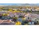Aerial view of homes showcasing tile roofs, multi-car garages and desert landscaping at 11890 Tevare Ln # 1098, Las Vegas, NV 89138