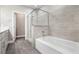 A spa-like bathroom features a gray-tiled shower and tub and a quartz countertop at 11890 Tevare Ln # 1098, Las Vegas, NV 89138