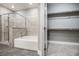A spa-like bathroom features a gray-tiled shower and tub and a gray walk-in closet at 11890 Tevare Ln # 1098, Las Vegas, NV 89138