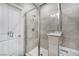 A spa-like gray tiled bathroom features a glass shower and a tub combo at 11890 Tevare Ln # 1098, Las Vegas, NV 89138