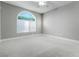 A neutral bedroom has gray walls, trim and carpet and a an arched window at 11890 Tevare Ln # 1098, Las Vegas, NV 89138
