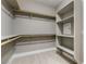 A gray walk-in closet features white trim and wooden closet rods and shelves at 11890 Tevare Ln # 1098, Las Vegas, NV 89138